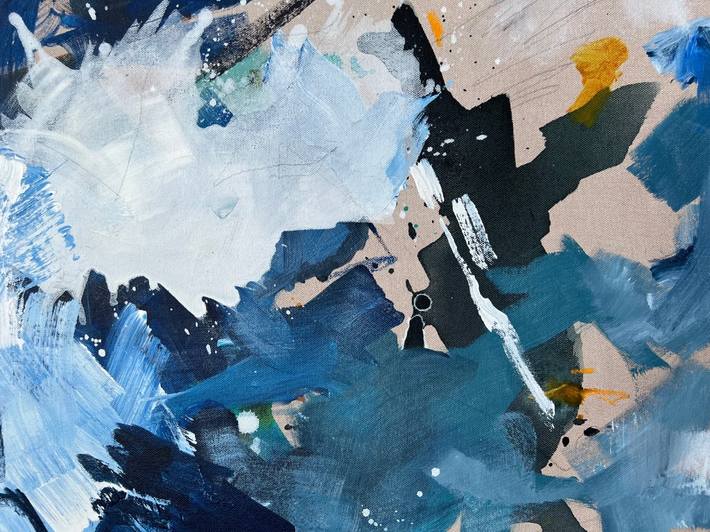 Close up of large blue and white paint on canvas